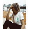 Girl wearing a white t-shirt with Friday Saturday Sunday restaurant logo on the front